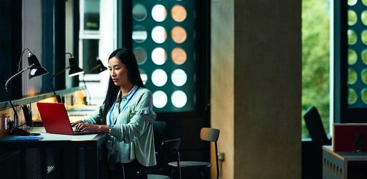 person on laptop standing at desk
