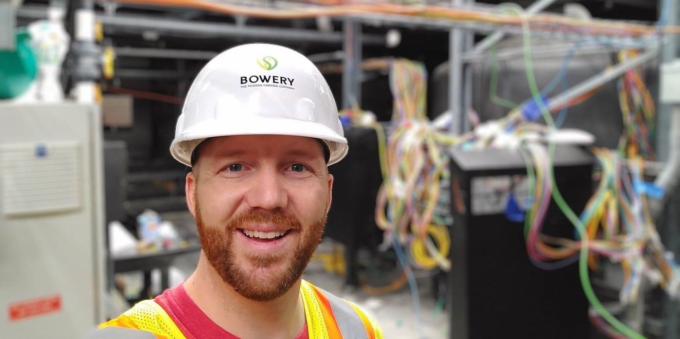 person smiling wearing a white hard hat